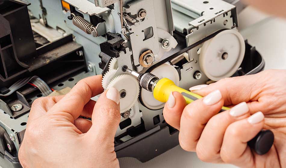 closeup shot young female technician repairing digital printer