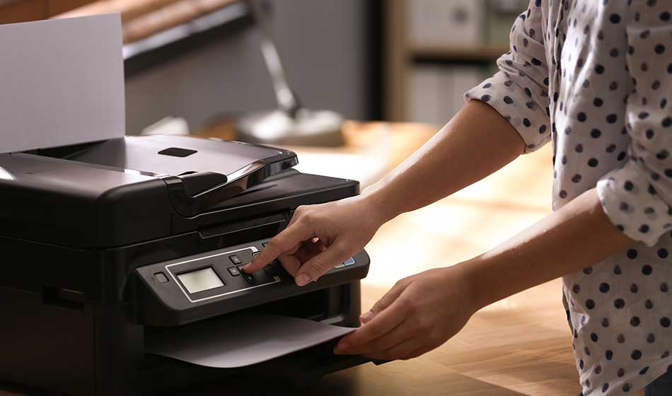 Employee using modern printer in office