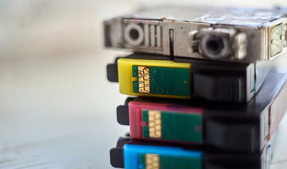 Four dried printer cartridges close up