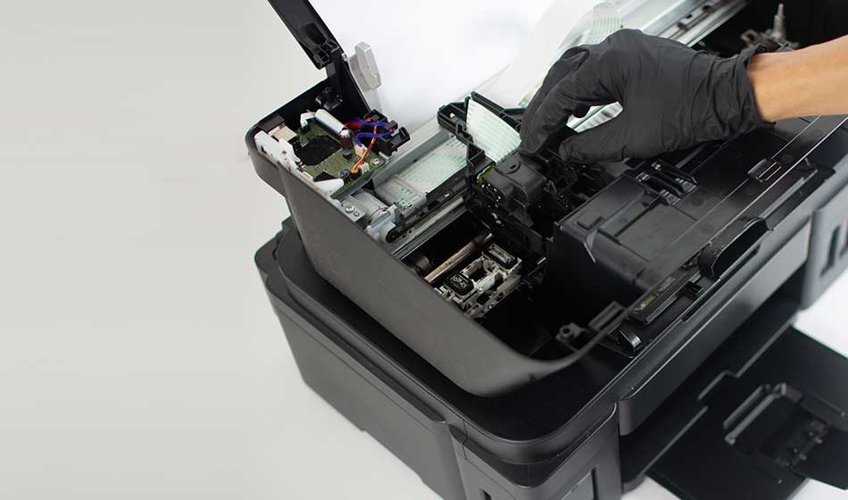 Printer repairman inspecting printer interior