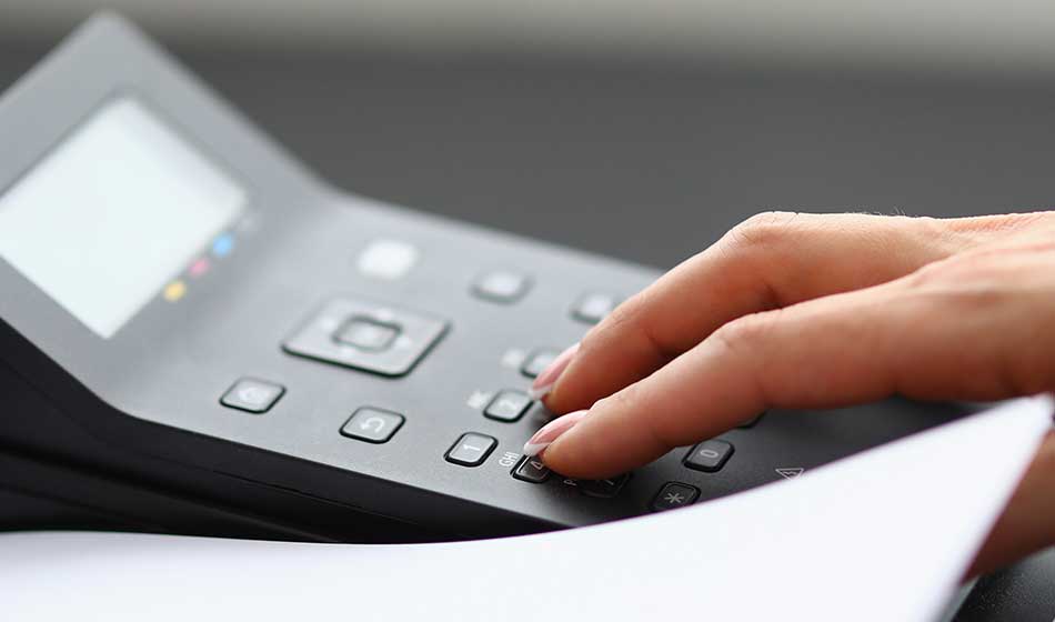 A woman uses office equipment to print